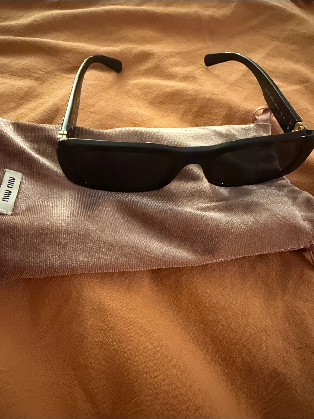 Miu Miu Black Rectangular Sunglasses with Gold Temple Accents